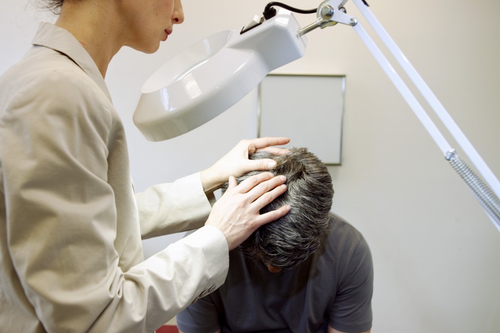 doctor checking a man's head