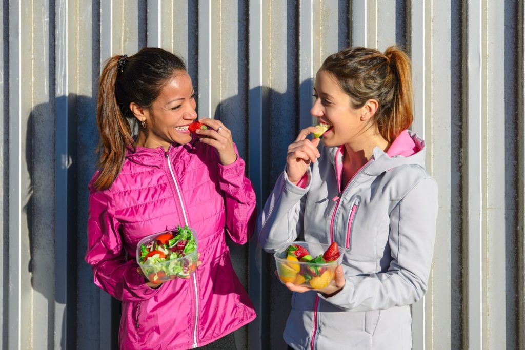 two women eating fruits