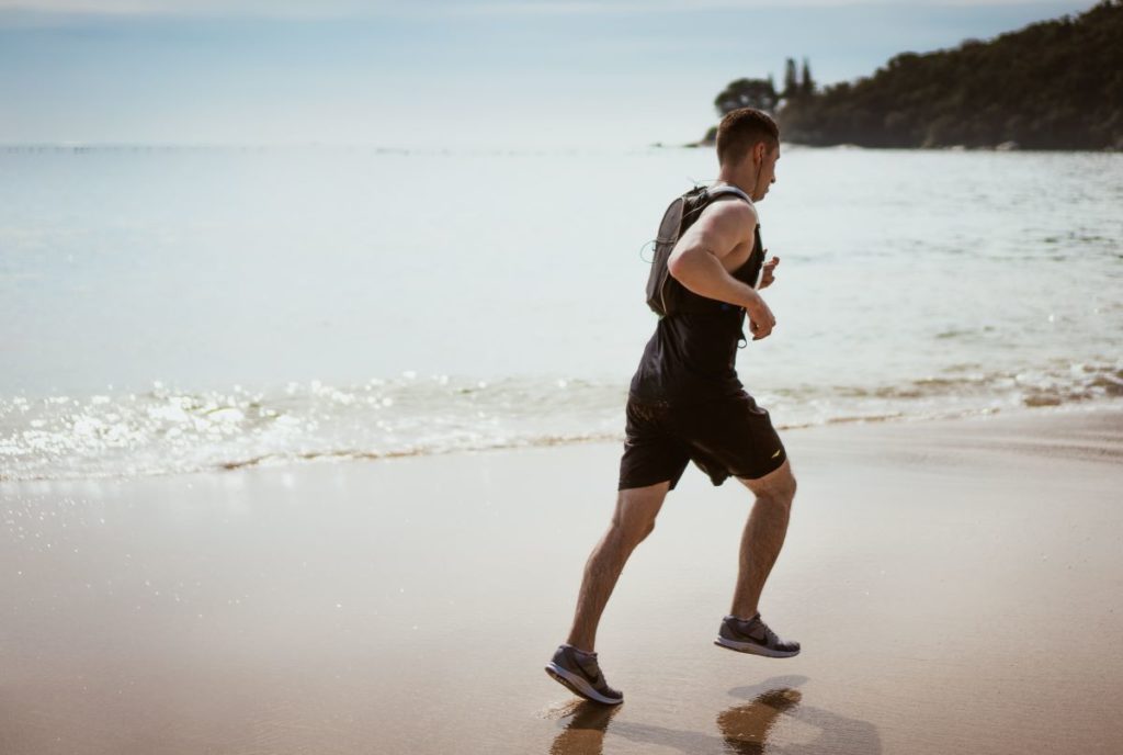 man jogging on the beach