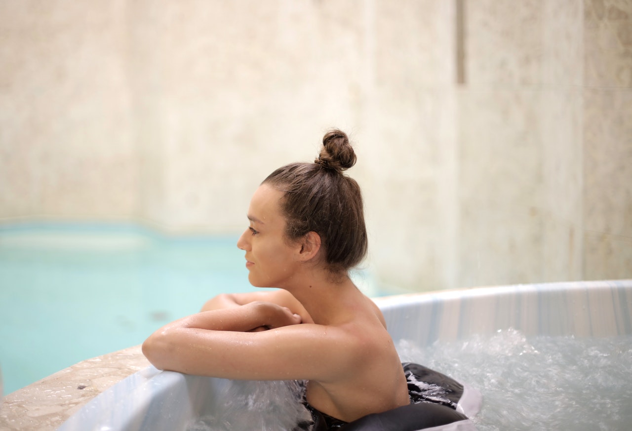 Woman taking a bath in a hot tub