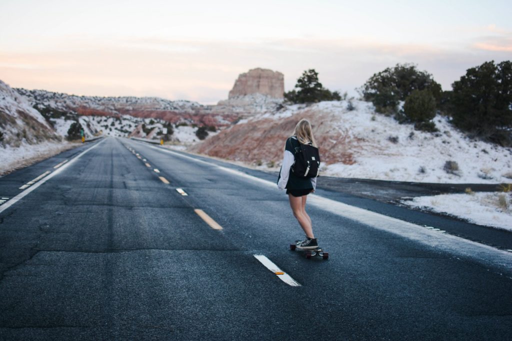 woman skateboarding on the road