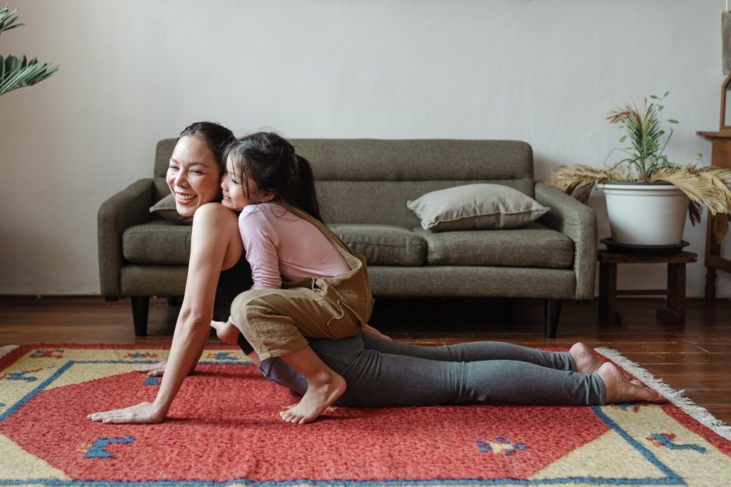 woman doing yoga with her child