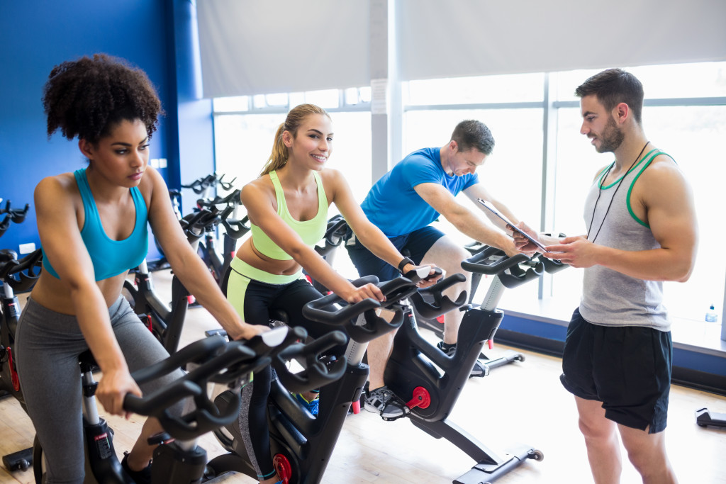 group of people using indoor cycling