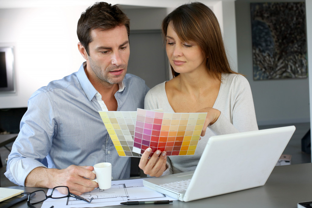 Young couple selecting paint for their home