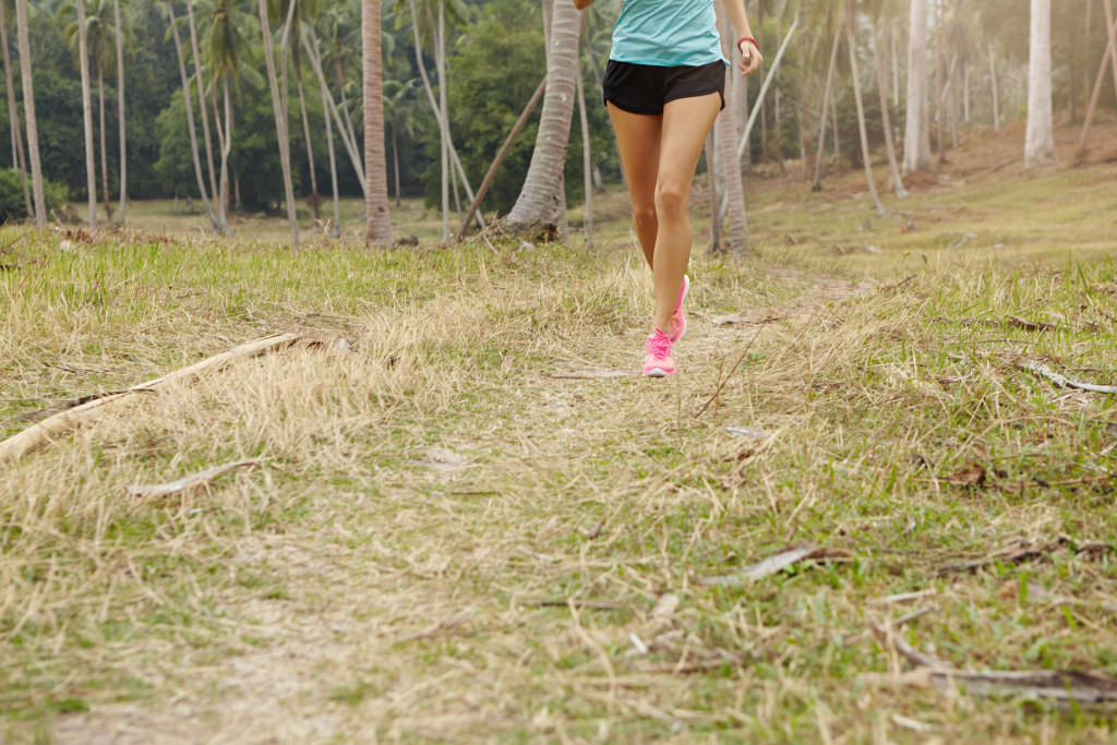 woman jogging on grass