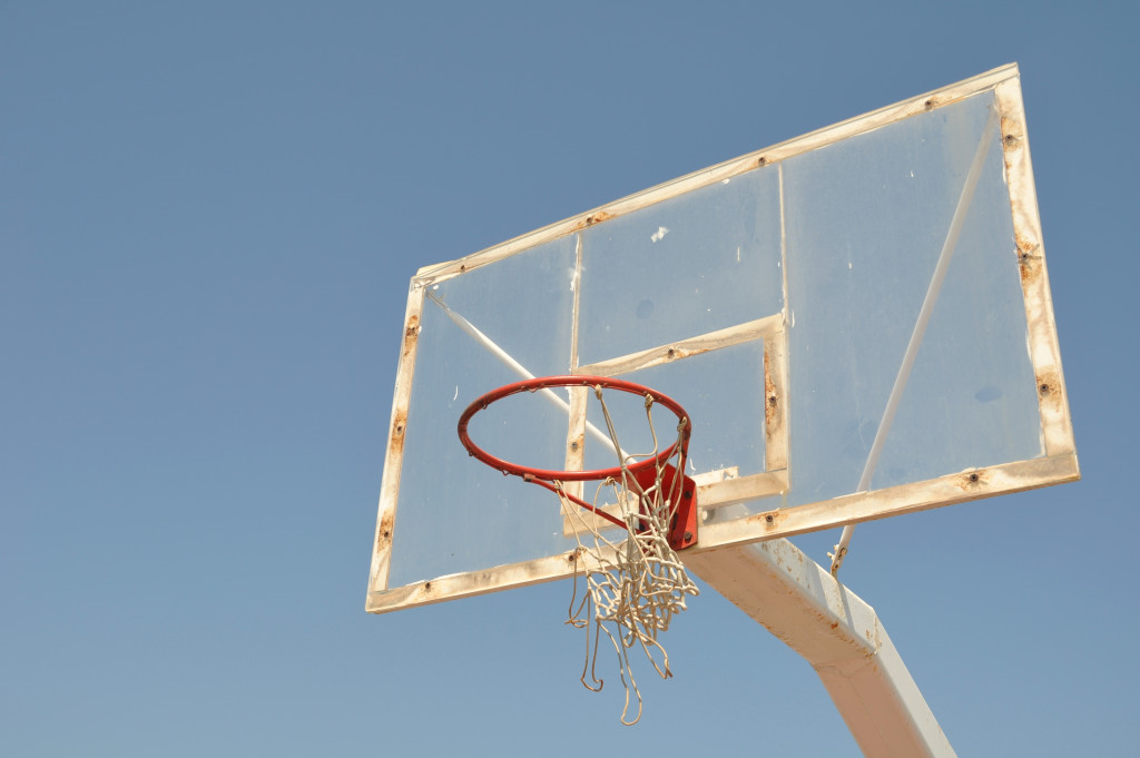 A rusty basketball hoop in the backyard