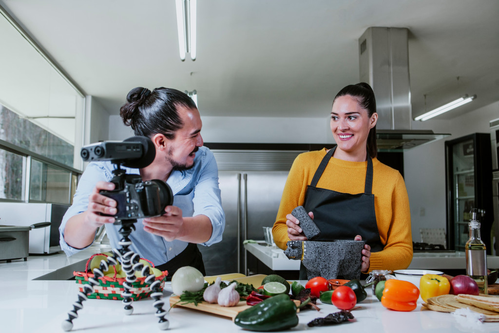 couple coking while recording with camera