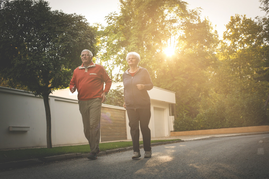 active senior couple running outdoors in the morning